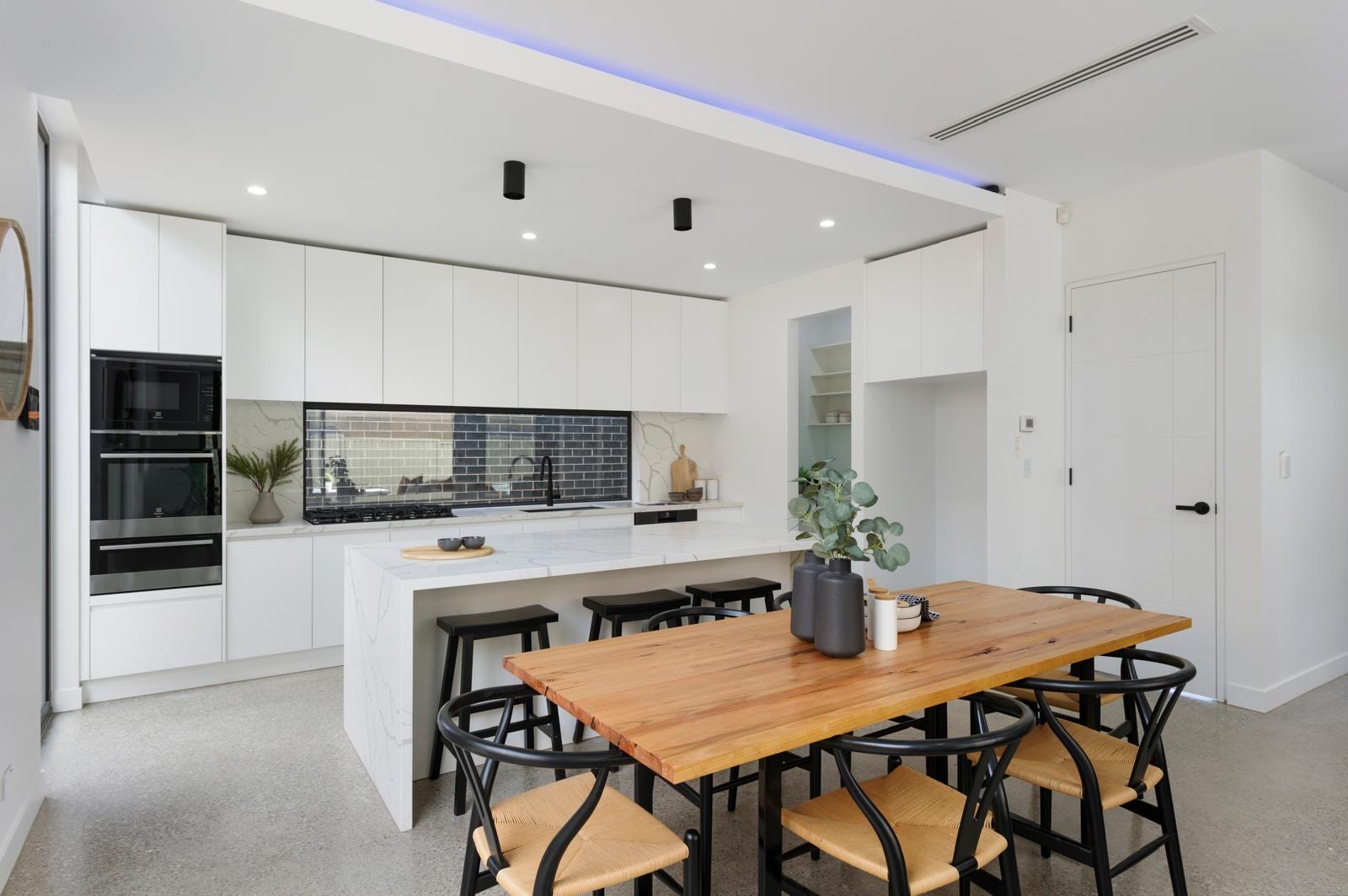 White and timber kitchen with dining setting, Bulleen